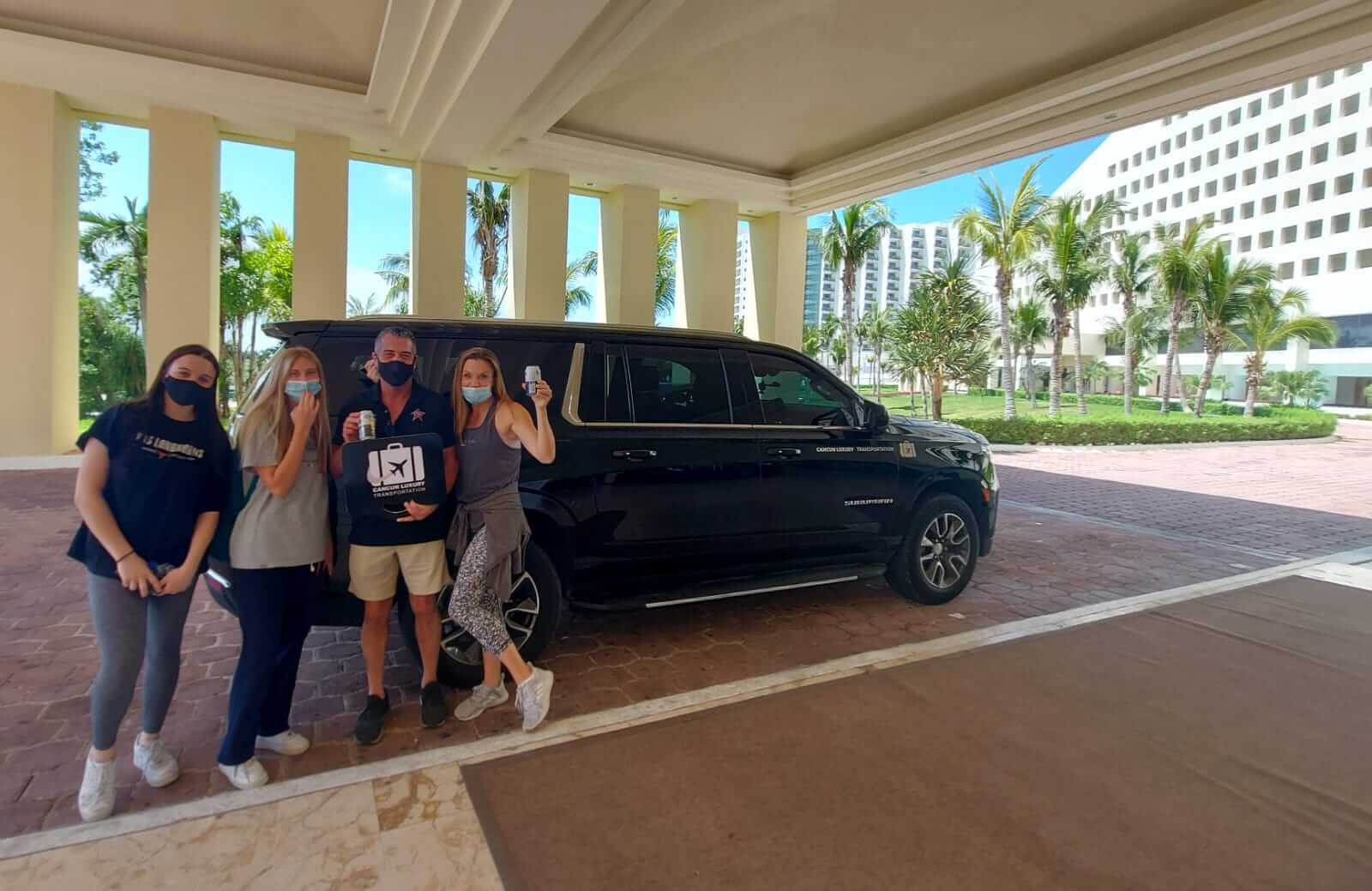 Family of four arriving at Cancun Hotel Zone by luxury transportation